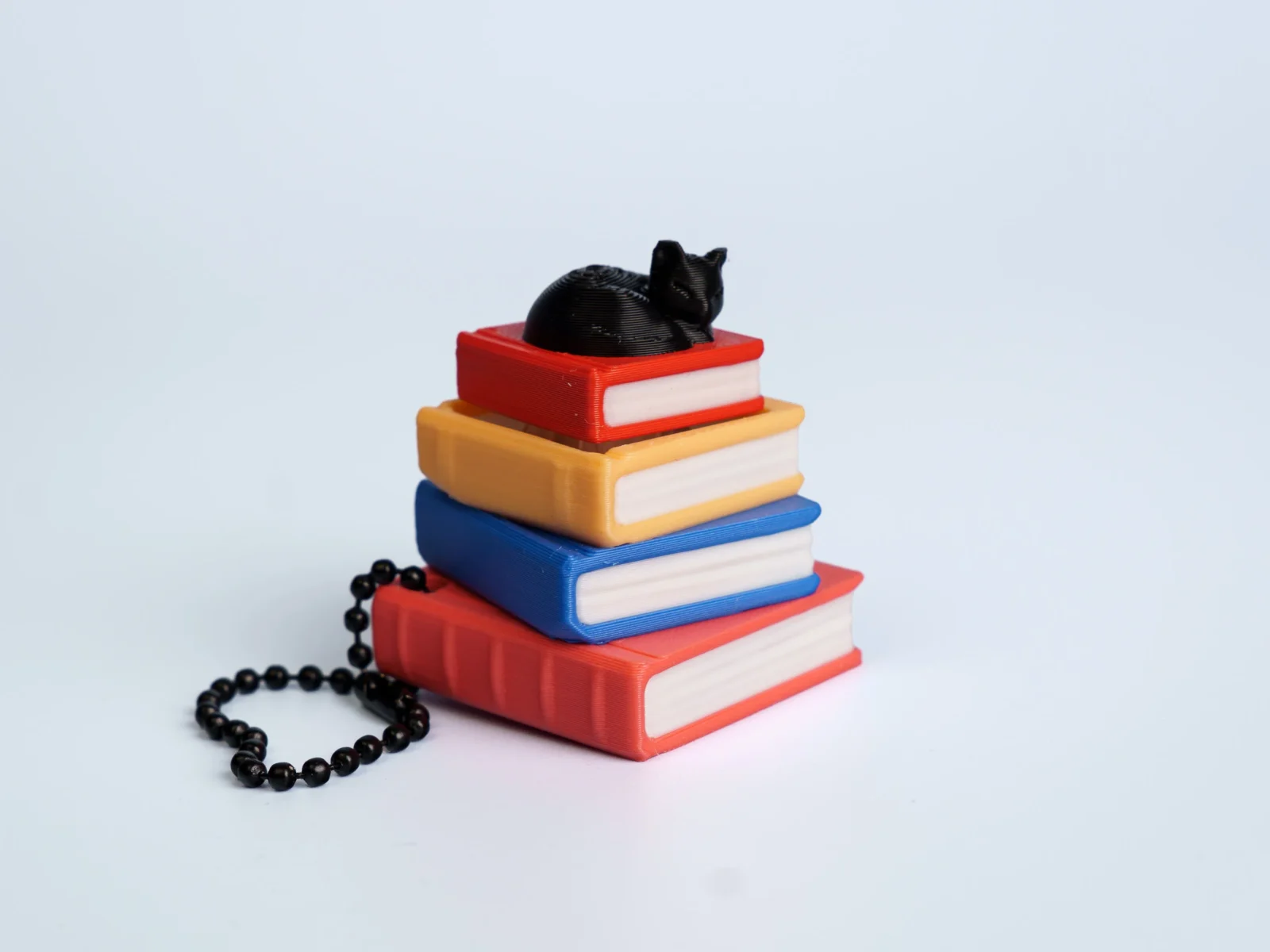 Enchanted Library clicker fidget keychain - black cat on books